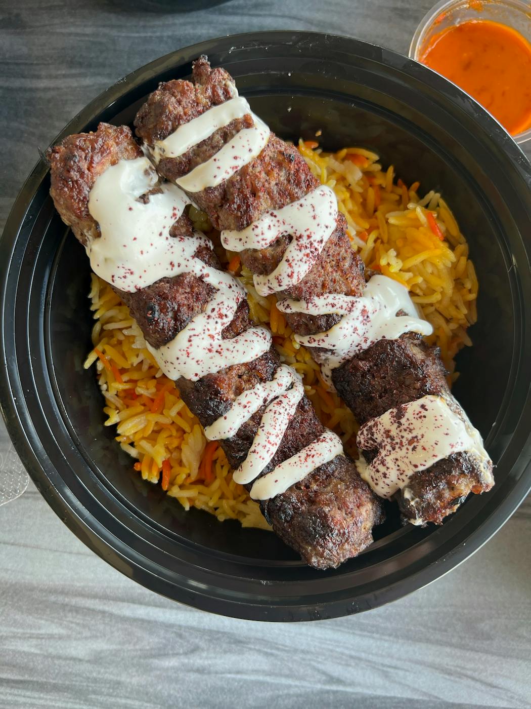 Wagyu beef kabobs served over seasoned rice