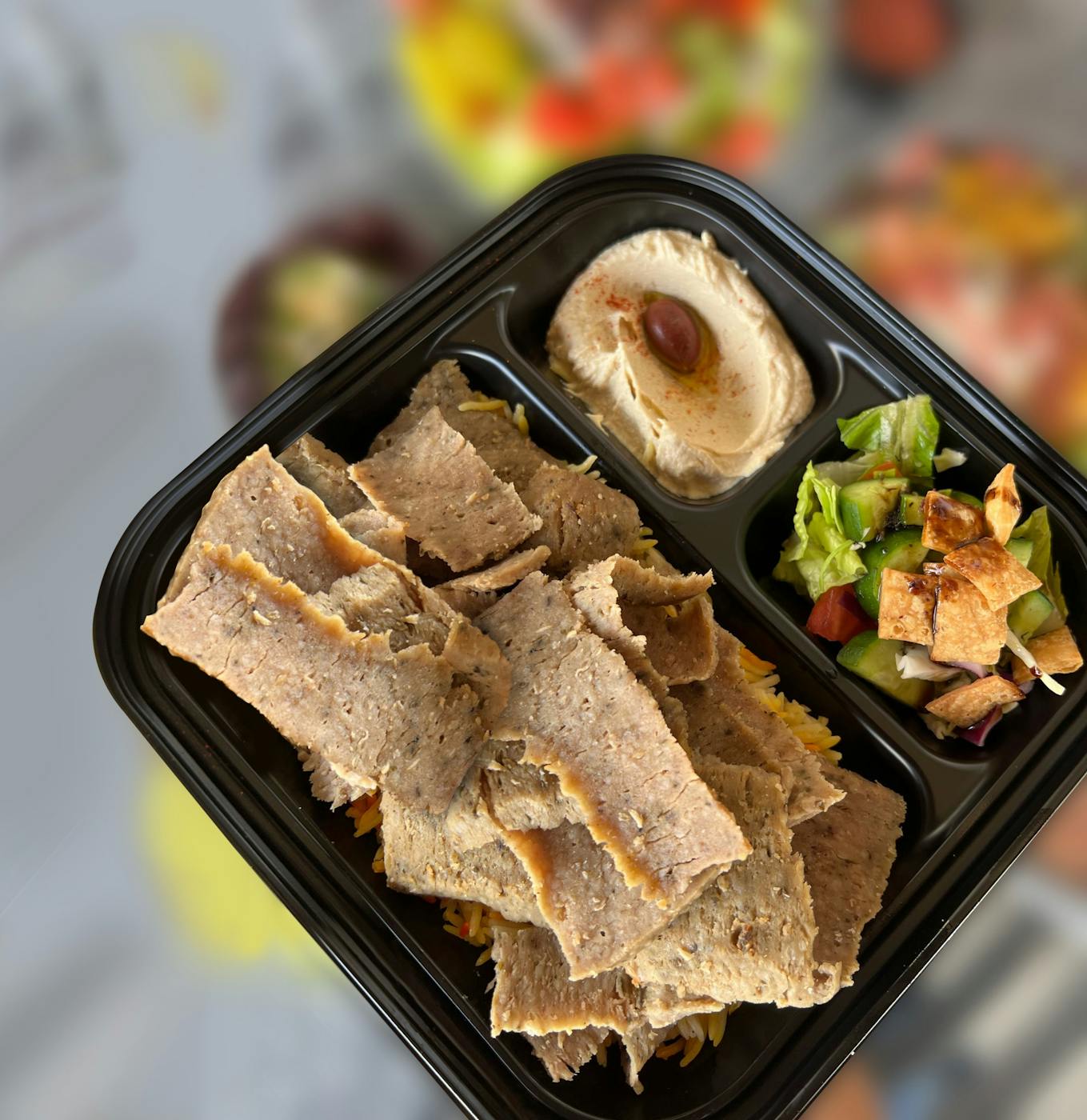 Shawarma platter with rice, hummus, and salad