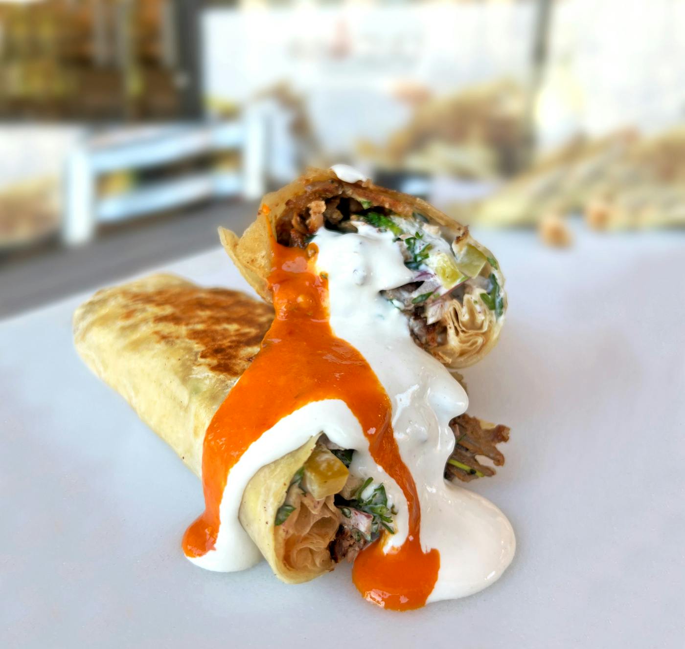 Sliced shawarma wraps served with house sauces